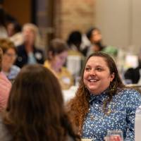 two people talking at luncheon table